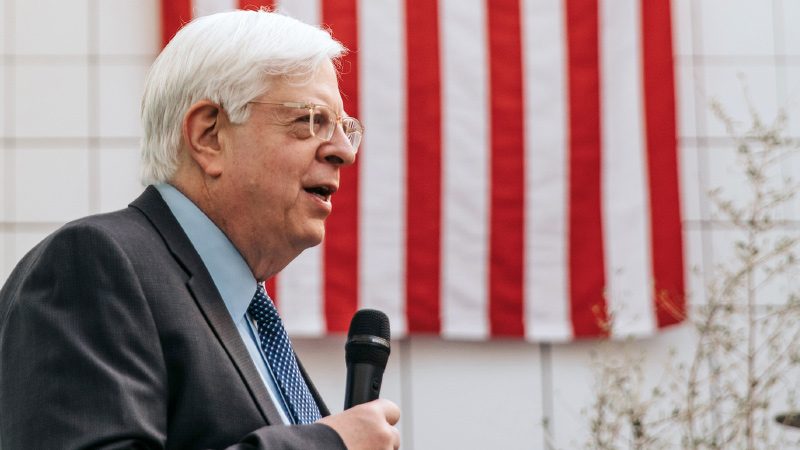 Photo of Dennis Prager holding a microphone